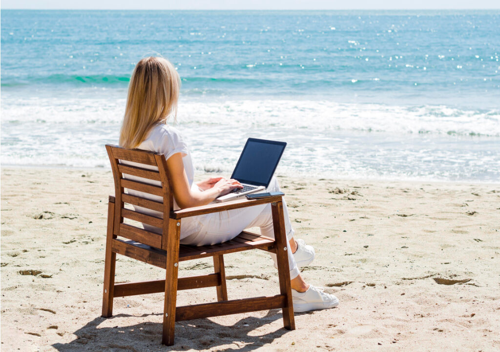 Woman Enjoying Beach While Working Laptop - North Cyprus Digital Nomad