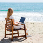 Woman Enjoying Beach While Working Laptop - North Cyprus Digital Nomad