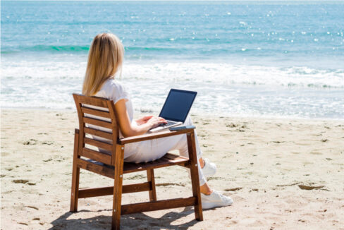 Woman Enjoying Beach While Working Laptop - North Cyprus Digital Nomad