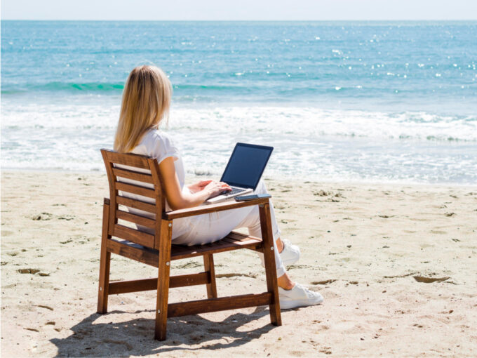 Woman Enjoying Beach While Working Laptop - North Cyprus Digital Nomad